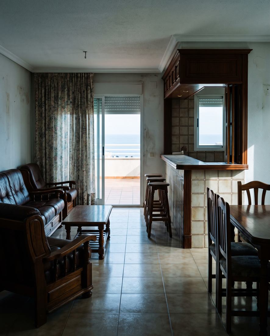 A dated 1990s apartment living room, the kind of resale home we renovate