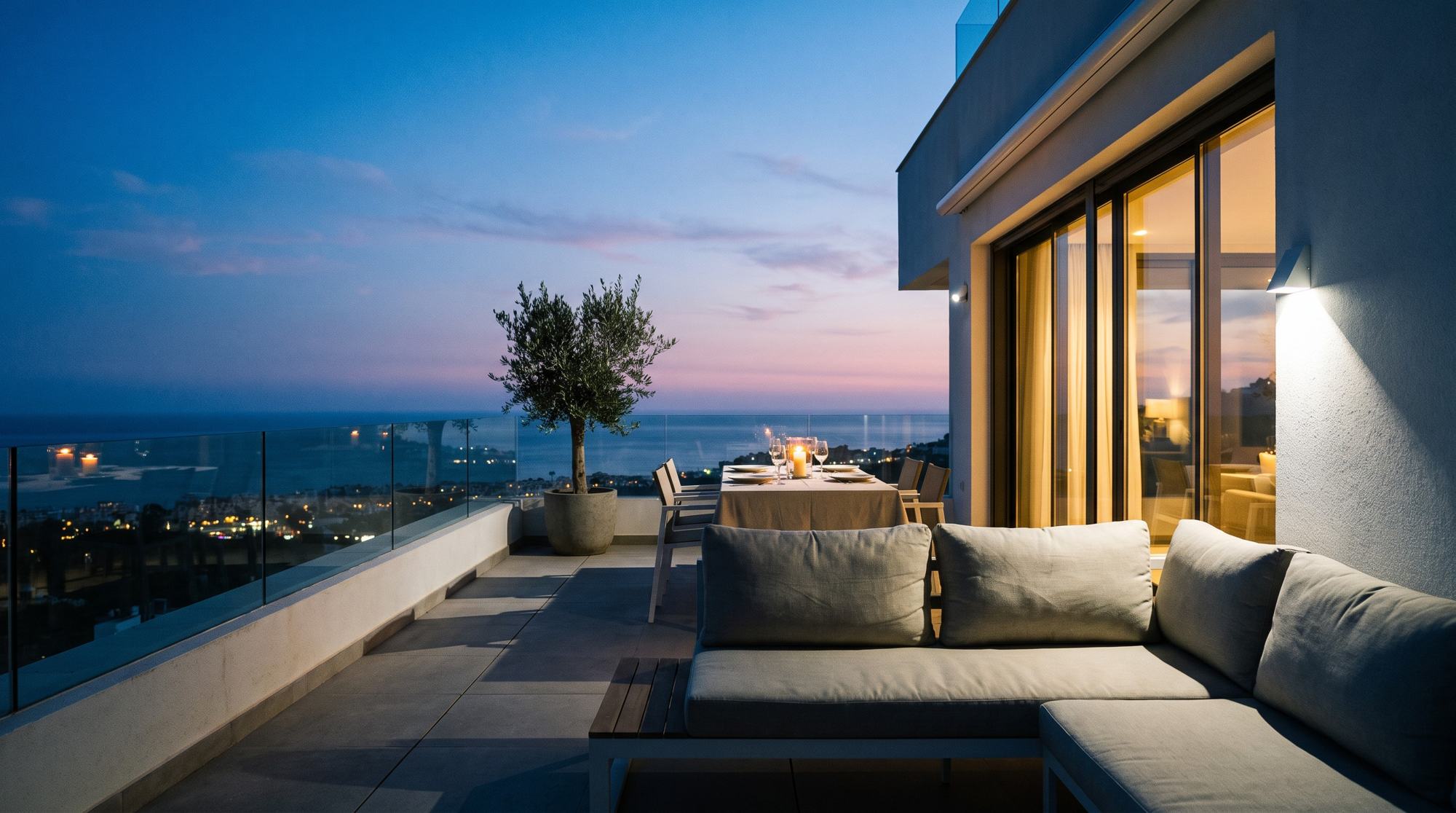 A new-build penthouse terrace at dusk above the sea